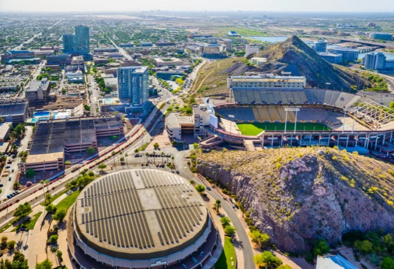 Urban cityscape with stadiums and mountains, showcasing Pipeliners USA's plumbing service area in Tempe, Arizona.