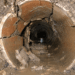 Damaged residential sewer line in Arizona showing cracked and deteriorated clay piping with debris inside the pipe.