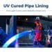 A glowing LED-cured liner being fed into a sewer line during a UV cured pipe lining installation