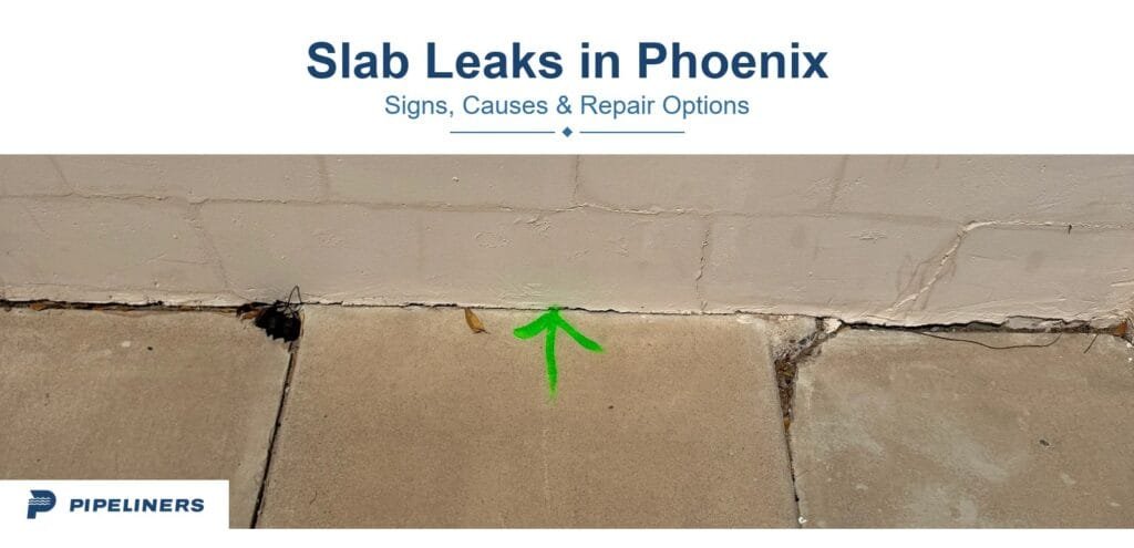 Green paint arrow marking a located leak where a concrete slab meets a block wall at a Phoenix property